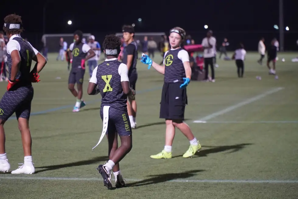 G1 Football Academy athletes playing under floodlights on an evening field